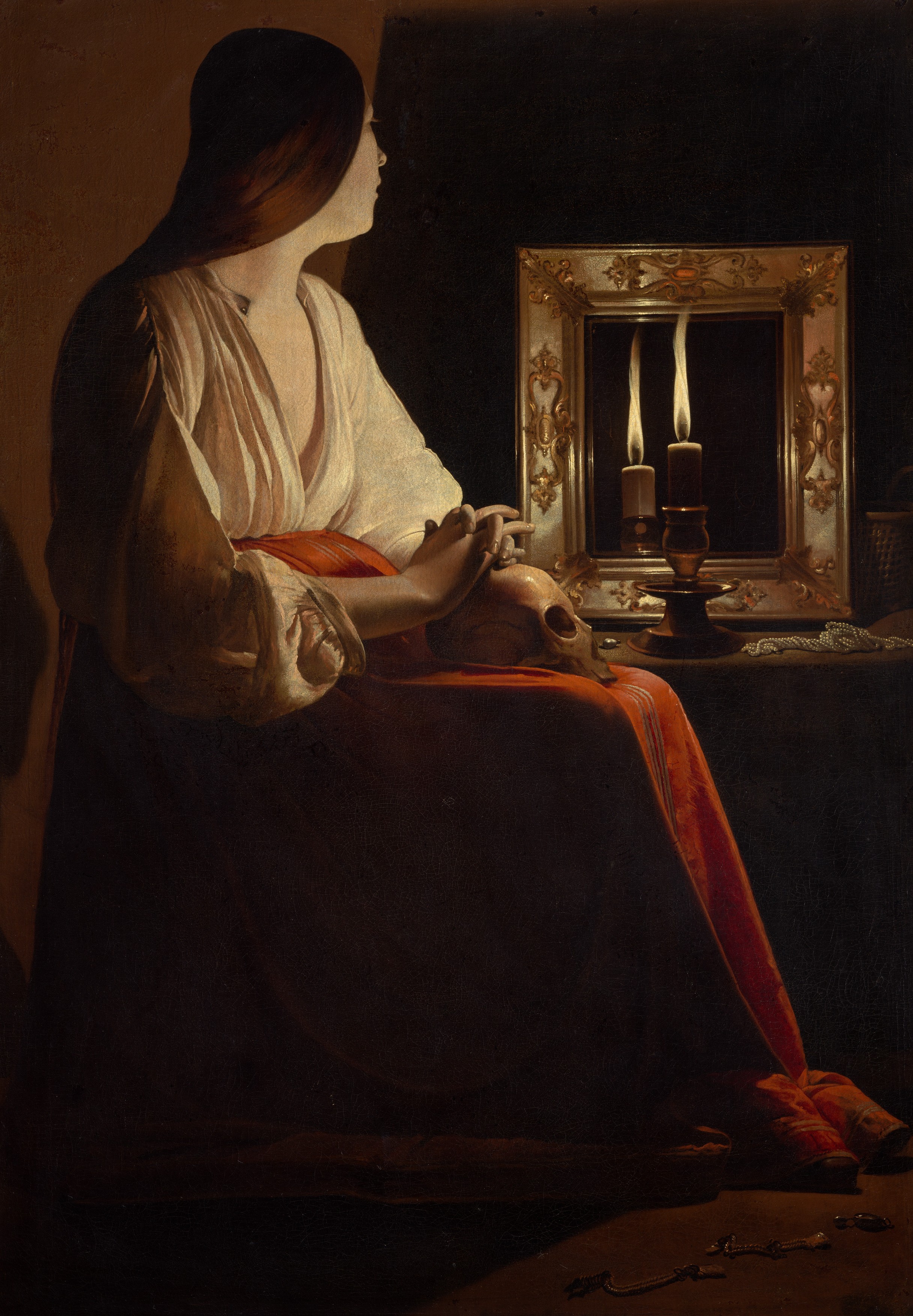 The Penitent Magdalen by Georges de La Tour: a young woman sits in the dark with her hands folded on a skull in her lap, looking at a candle doubled in a mirror on the table